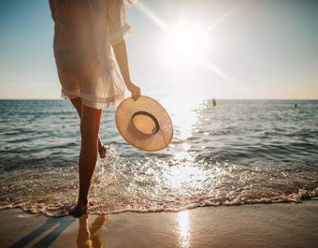 Woman walking on the beach during vacation